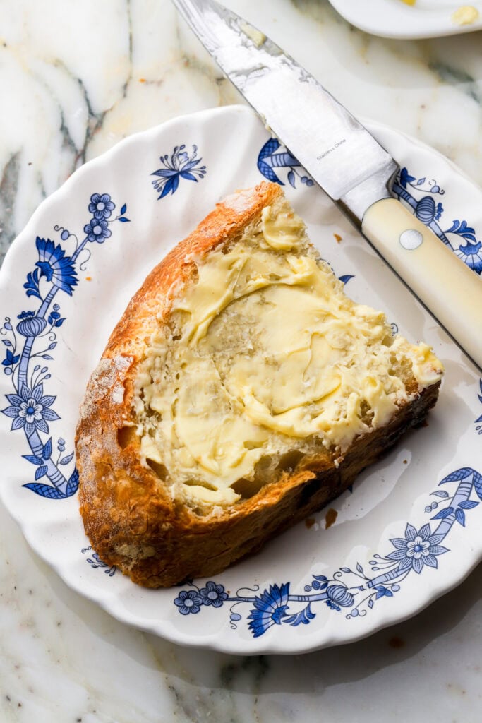 slice of italian bread on a plate with butter