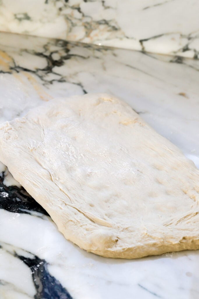 stretch dough out onto lightly floured surface