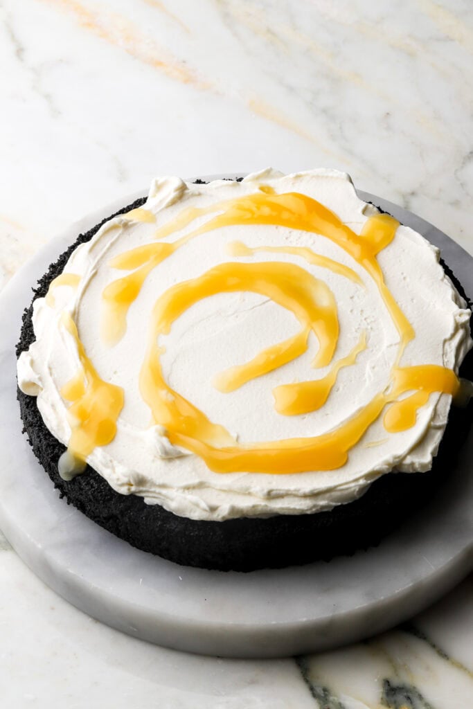 lemon mascarpone cream and lemon curd on the first layer of chocolate cake