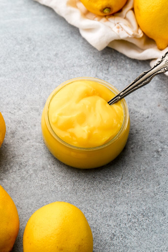 lemon curd in a jar with a spoon