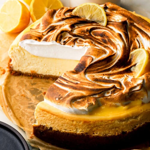 lemon meringue cheesecake with a slice cut out to show the inside