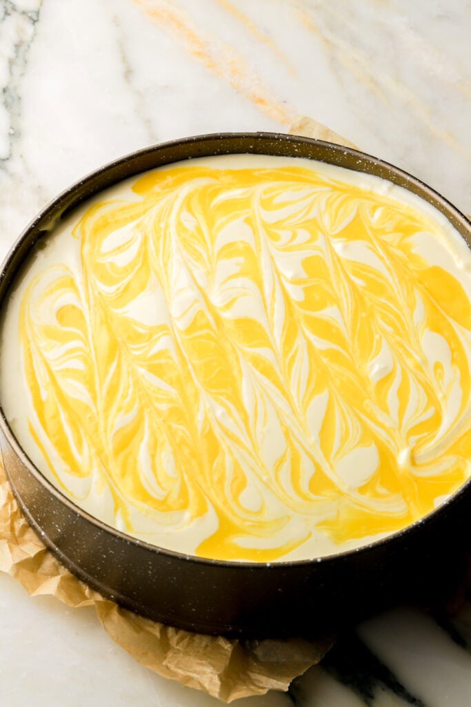 cheesecake layered and swirled with lemon curd