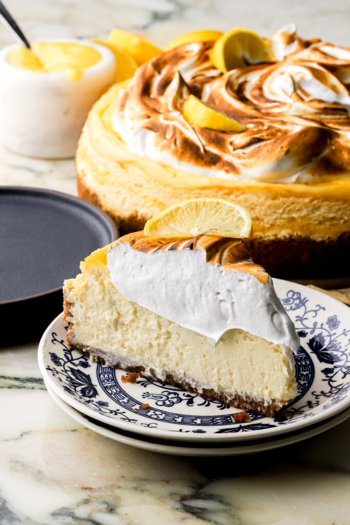 slice of lemon meringue cheesecake on a plate