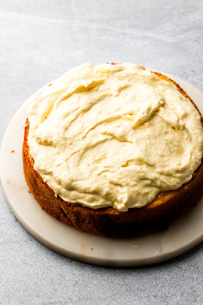 mango diplomat cream spread onto first layer of cake