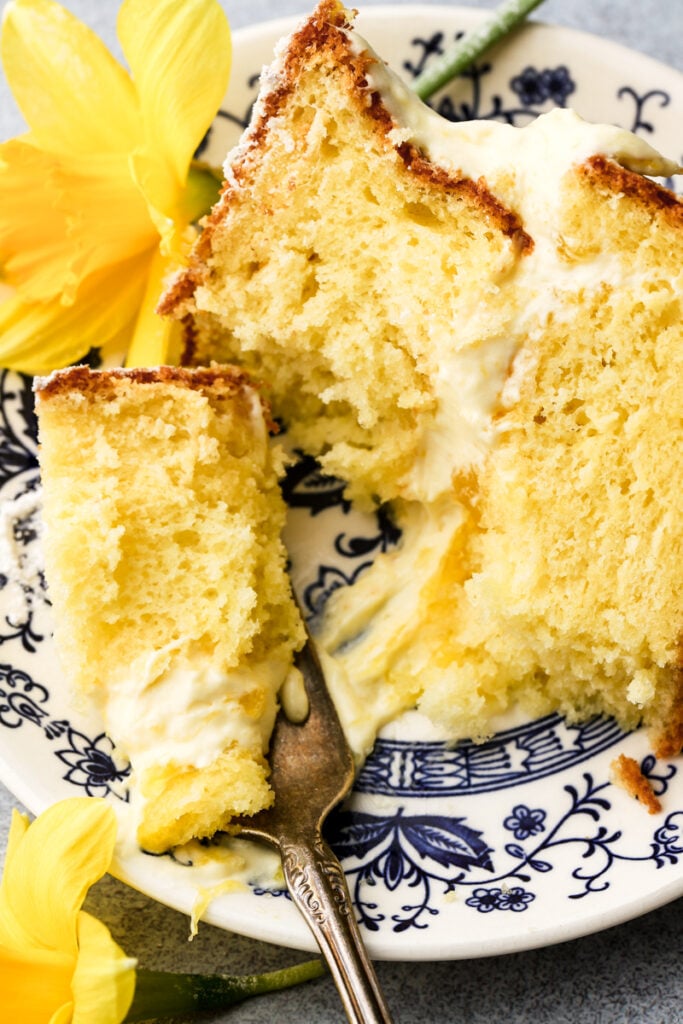 mango cake sliced on a plate and a bite taken out