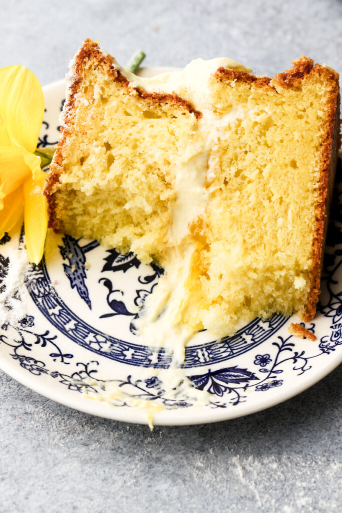 mango cake sliced on a plate and a bite taken out