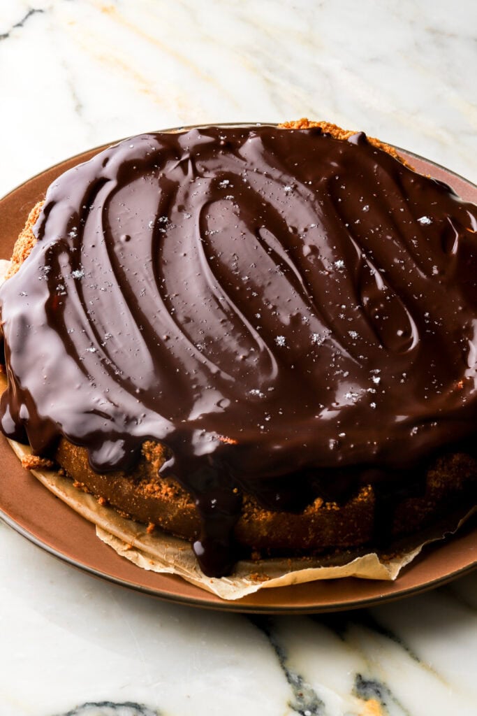 chocolate poured on top of the caramel and cheesecake