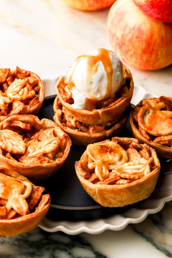 mini apple pies in a plate with ice cream