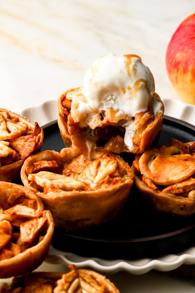 mini apples pies topped with vanilla ice cream
