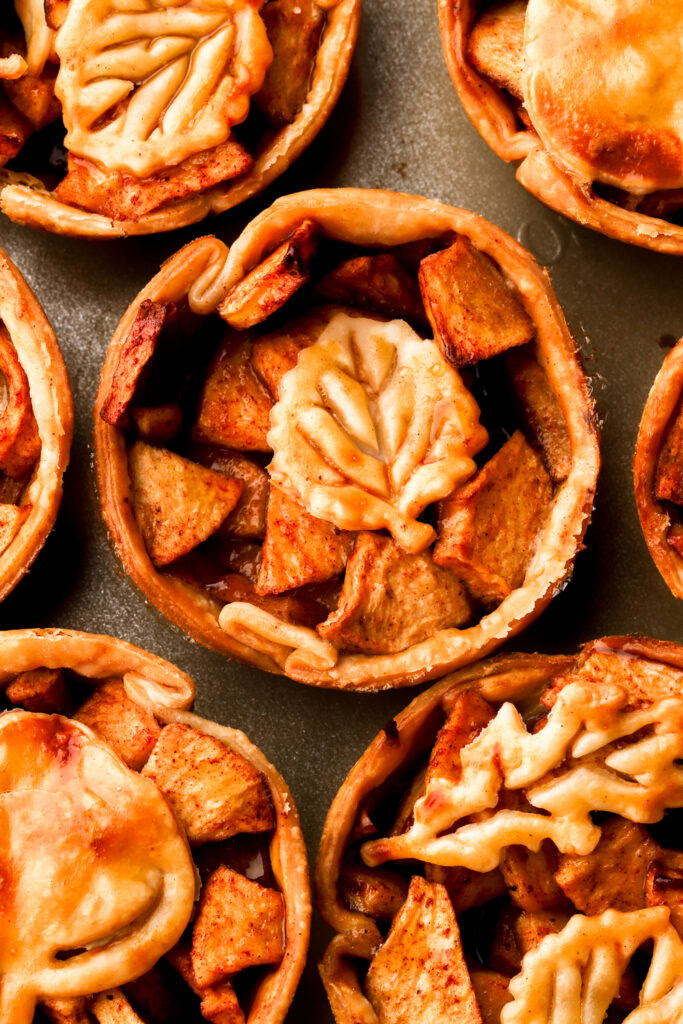close up of apples pies with leaf designs