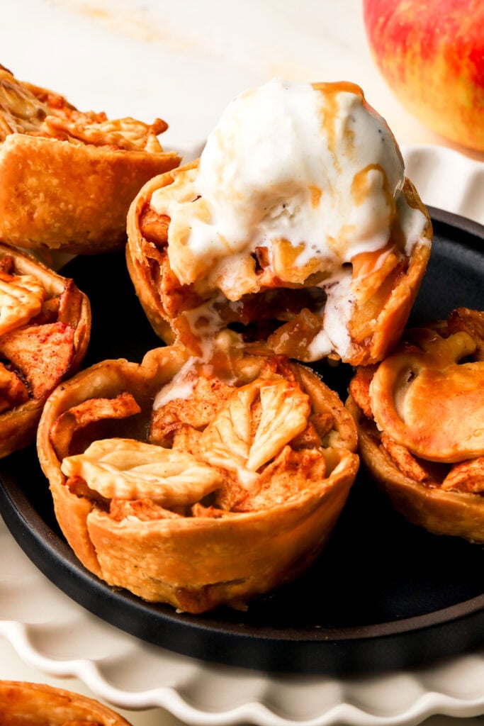mini apple pies topped with vanilla ice cream