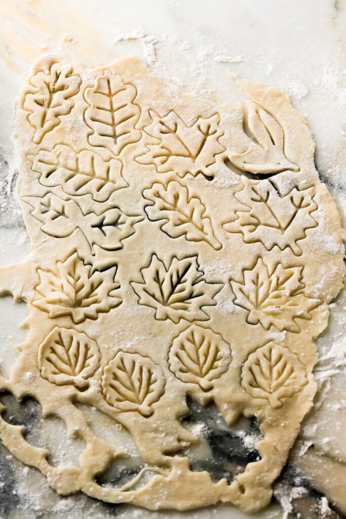 roll out pie crust dough and cut out desired shapes