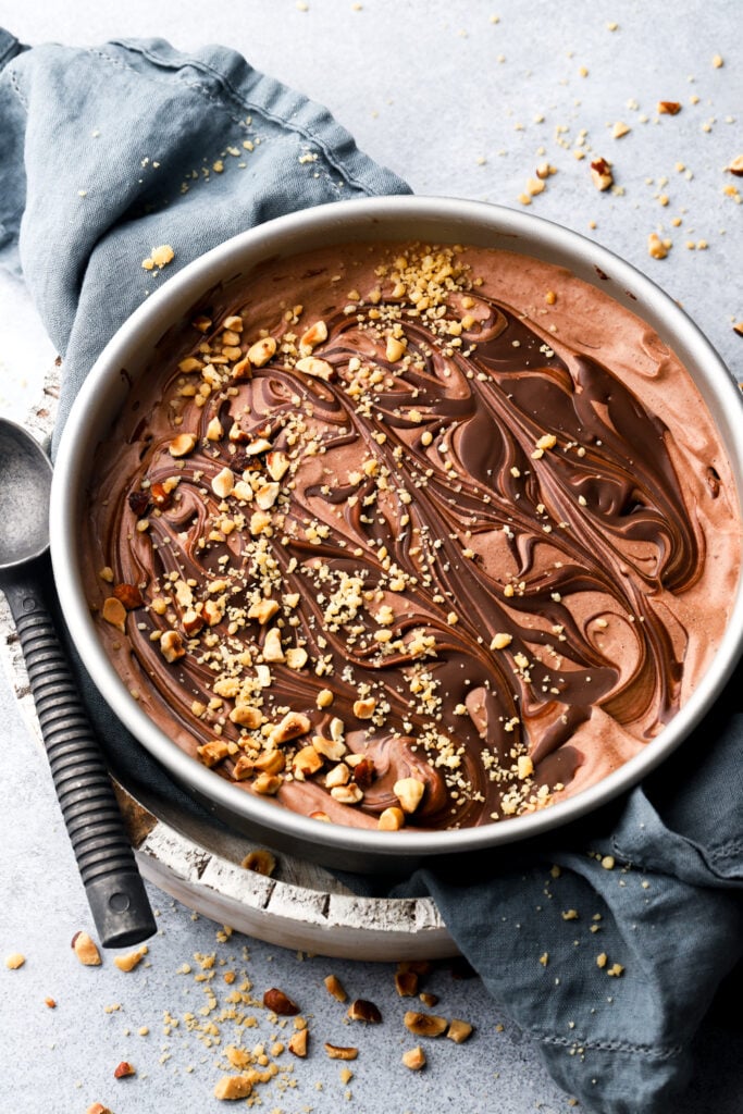 nutella ice cream topped with nutella swirls and hazelnuts