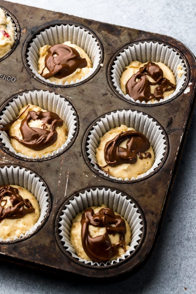 nutella muffin batter in a pan filled half way 