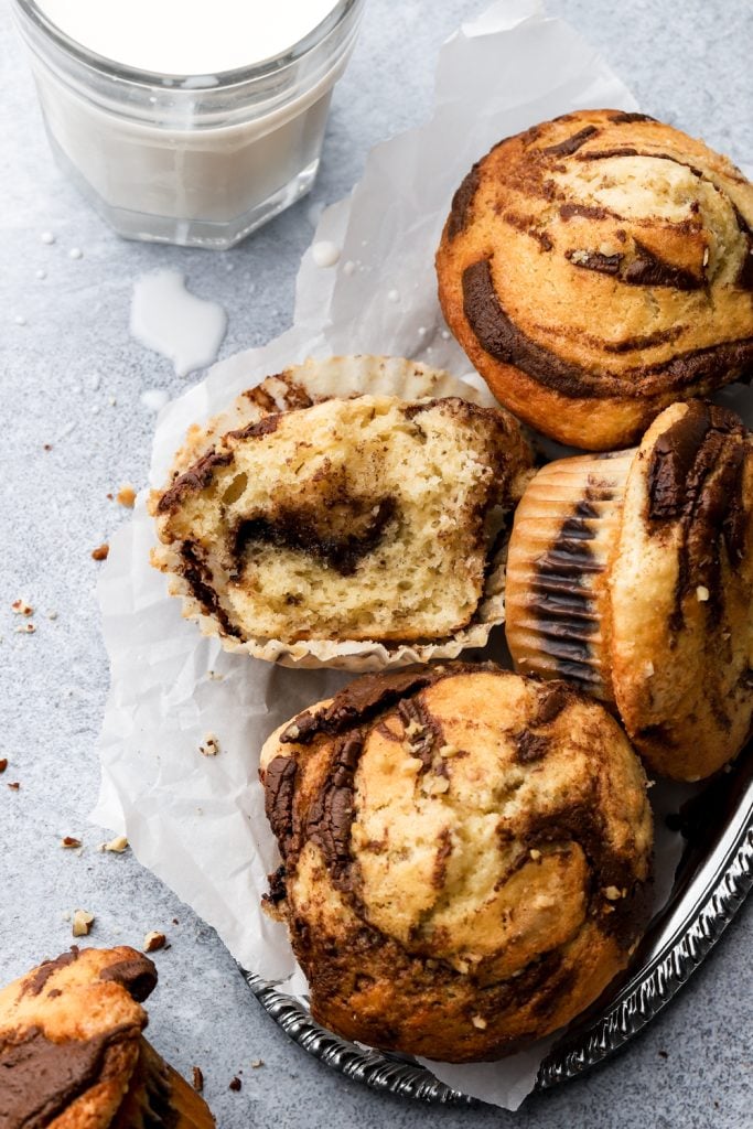 bitten nutella muffin next to a cup of milk