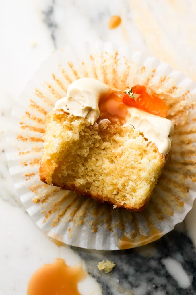 bite taken out of an orange cupcake