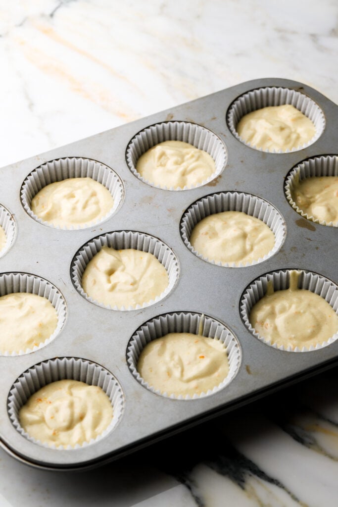 orange cupcake batter in pan