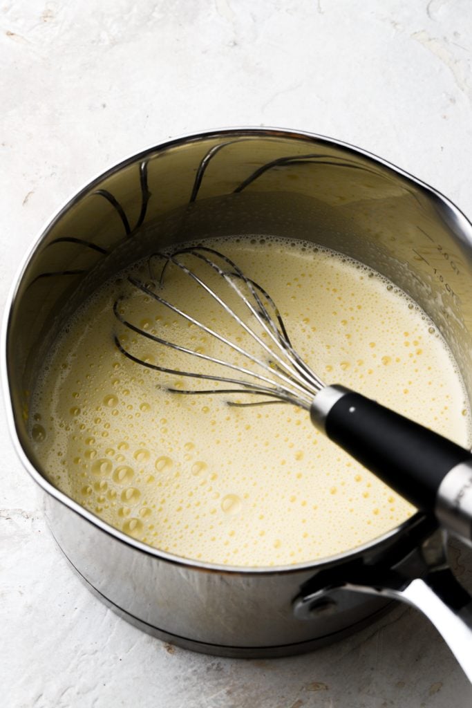 eggs tempered with milk in saucepan