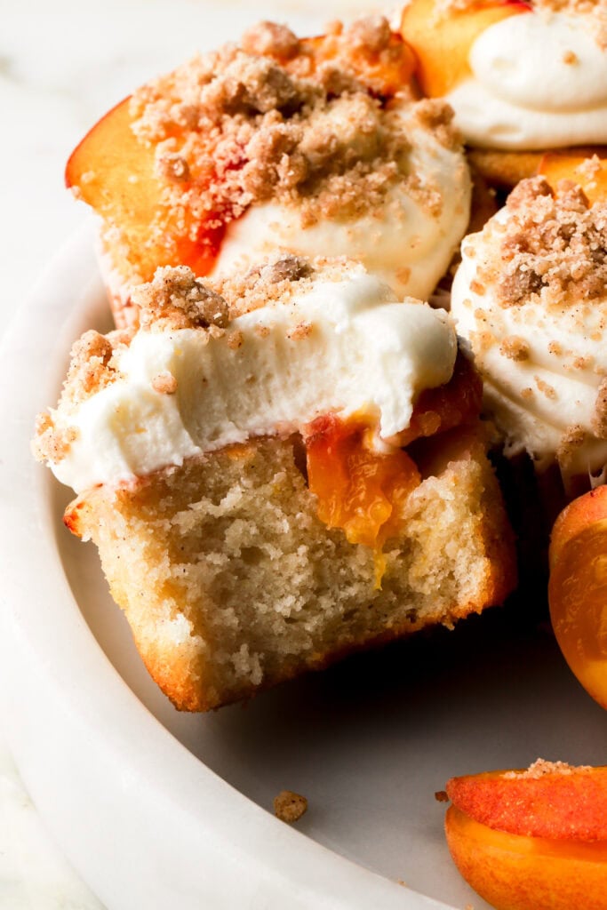 bite taken out of a peach cobbler cupcake