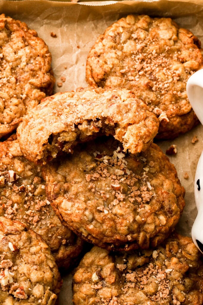 close up of a pecan oatmeal cookie with a bite taken out