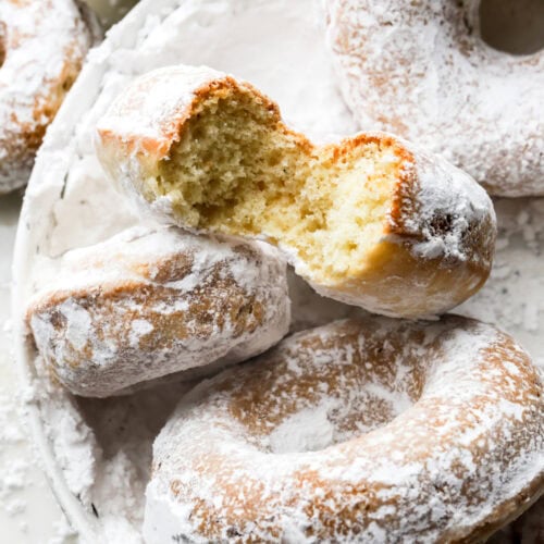 bite taken out of a powdered sugar donut