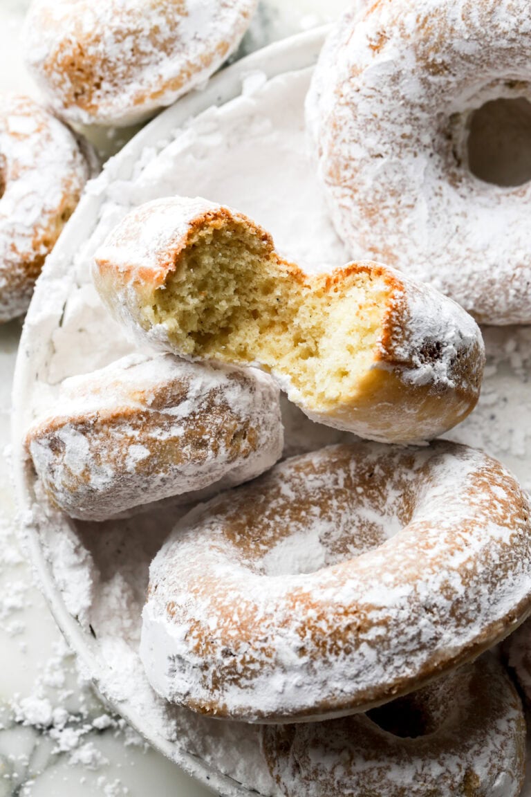 bite taken out of a powdered sugar donut