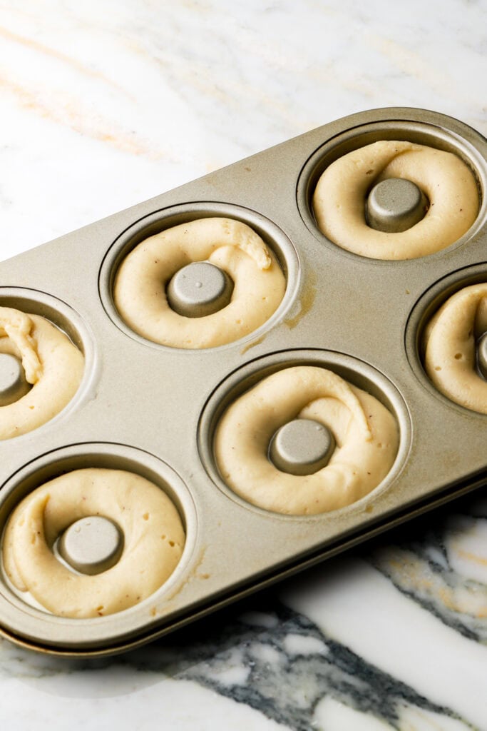 donut batter piped into molds