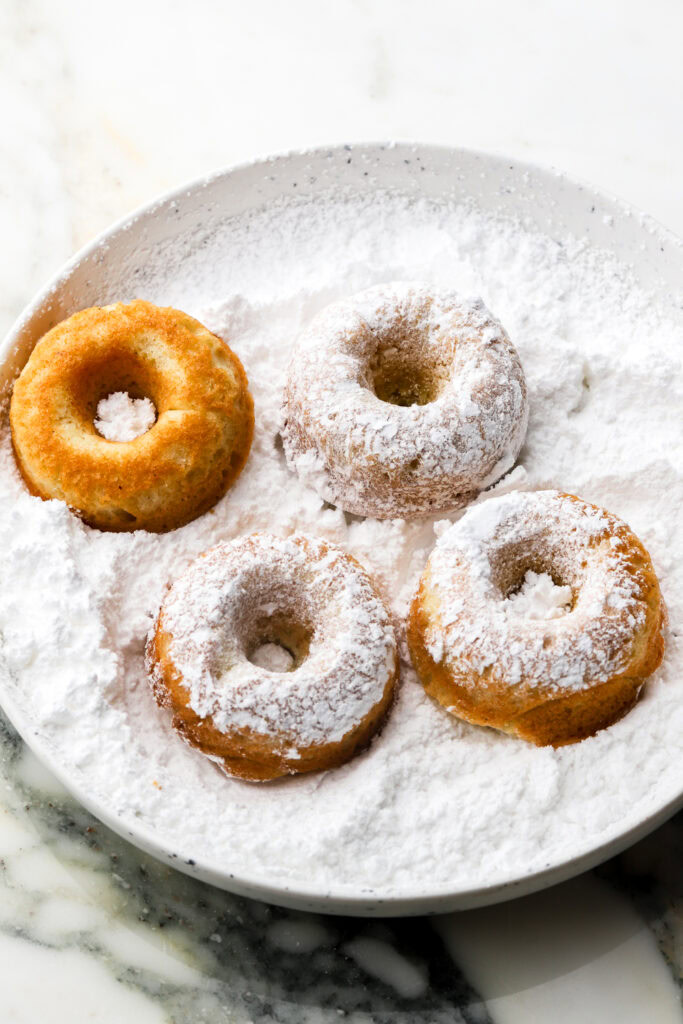 mini donuts tossed in powdered sugar 