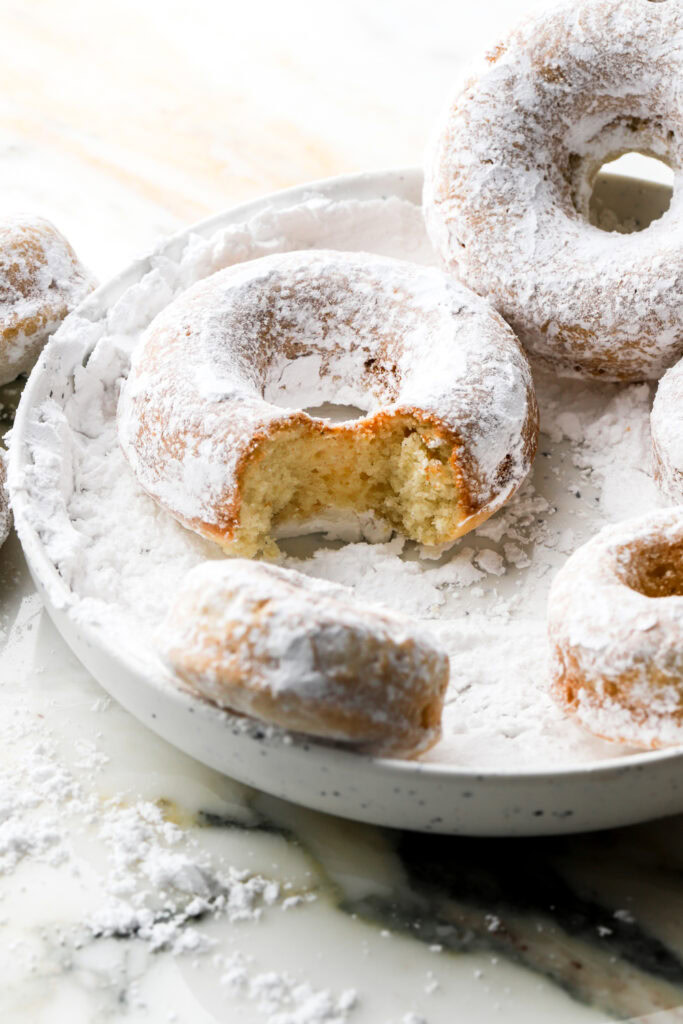 bite taken out of a powdered sugar donut