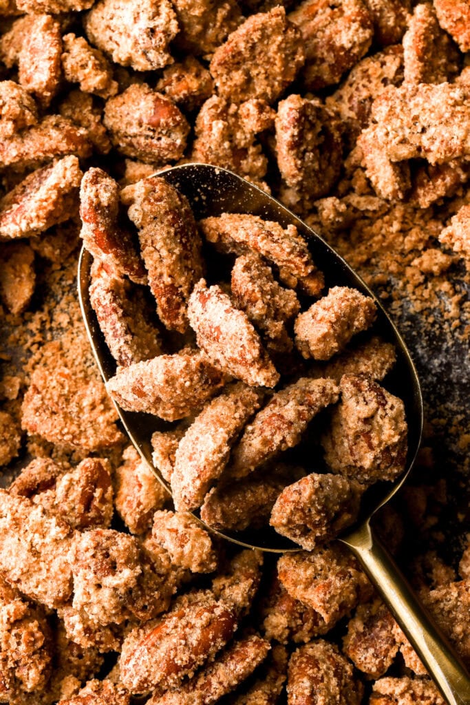 praline pecans getting scooped out of the pan