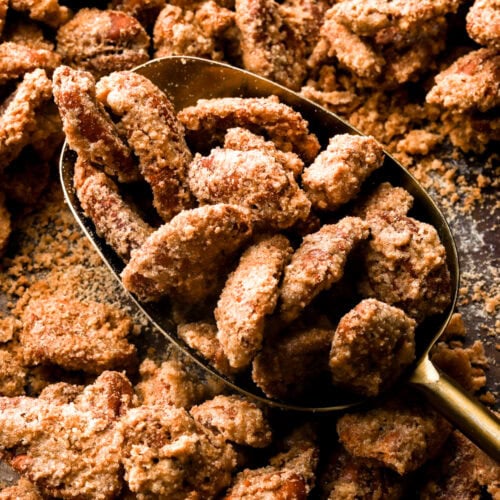 praline pecans getting scooped out of the pan