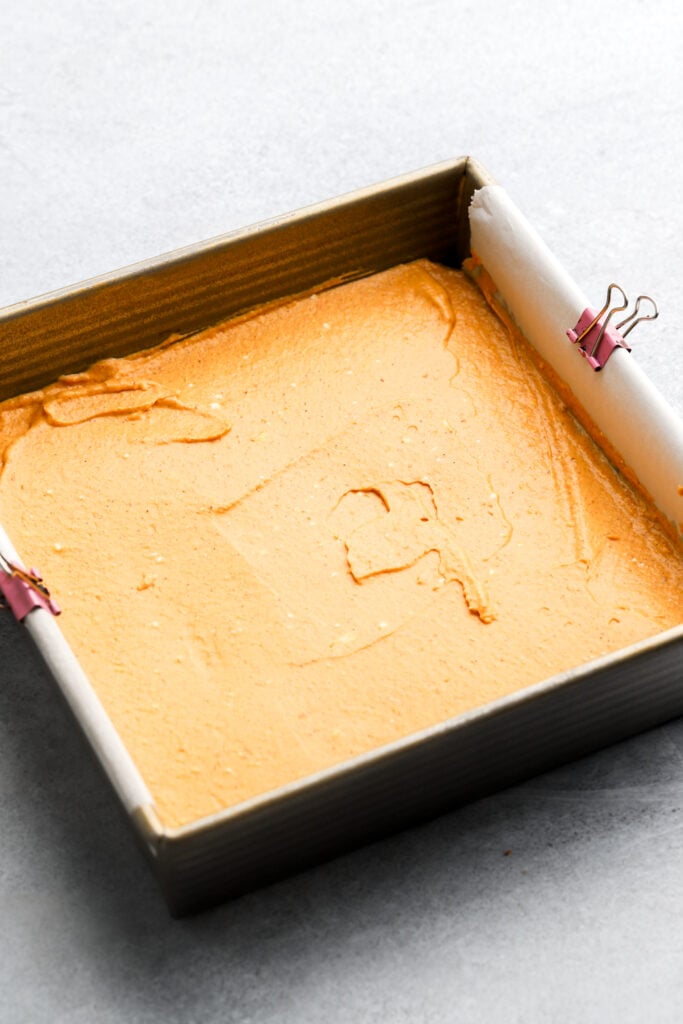 pumpkin cheesecake layer on top of brownie batter