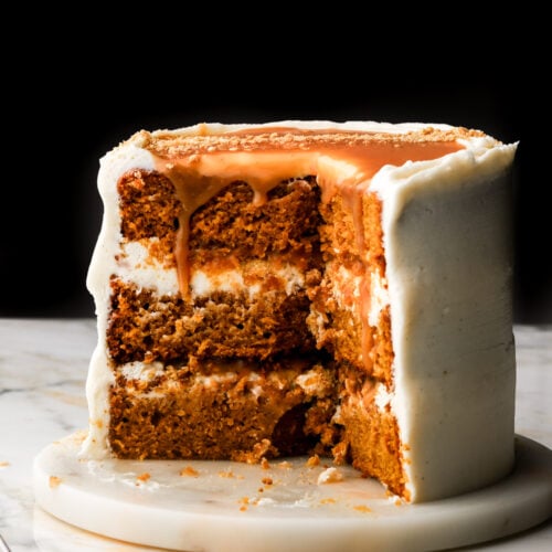 pumpkin cake on a marble surface with caramel dripping down