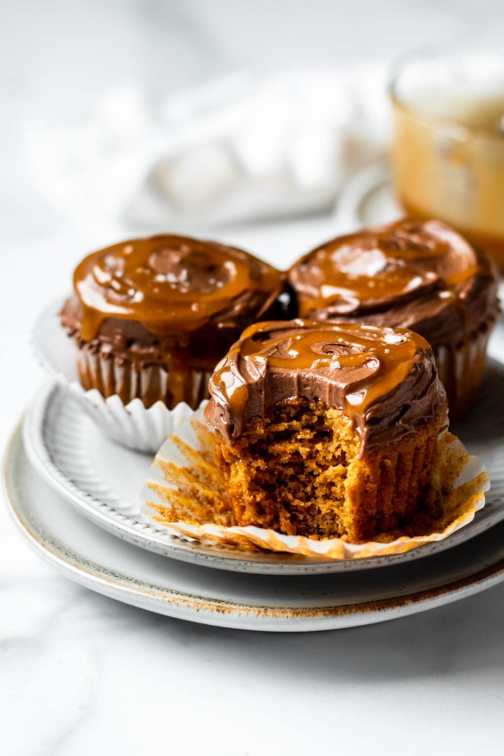 spiced pumpkin cupcakes with chocolate cream cheese frosting and salted caramel