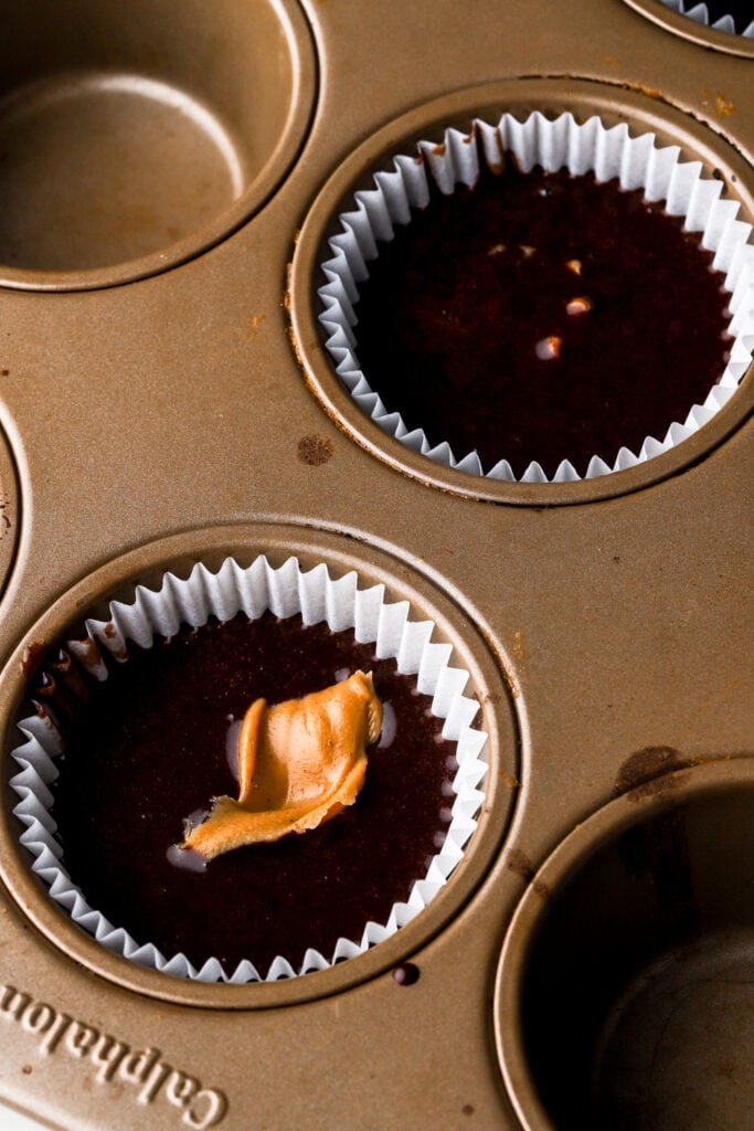 peanut butter stuffed into the center of the cupcake batter (make sure to press it into the batter).