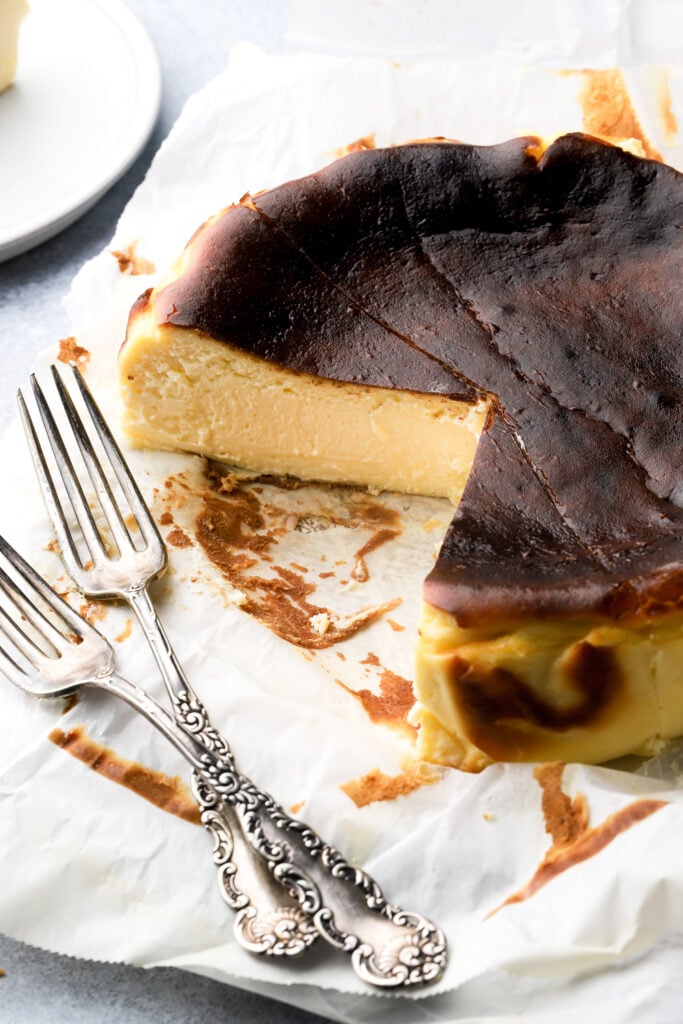 san sebastian cheesecake cut into with a couple of forks