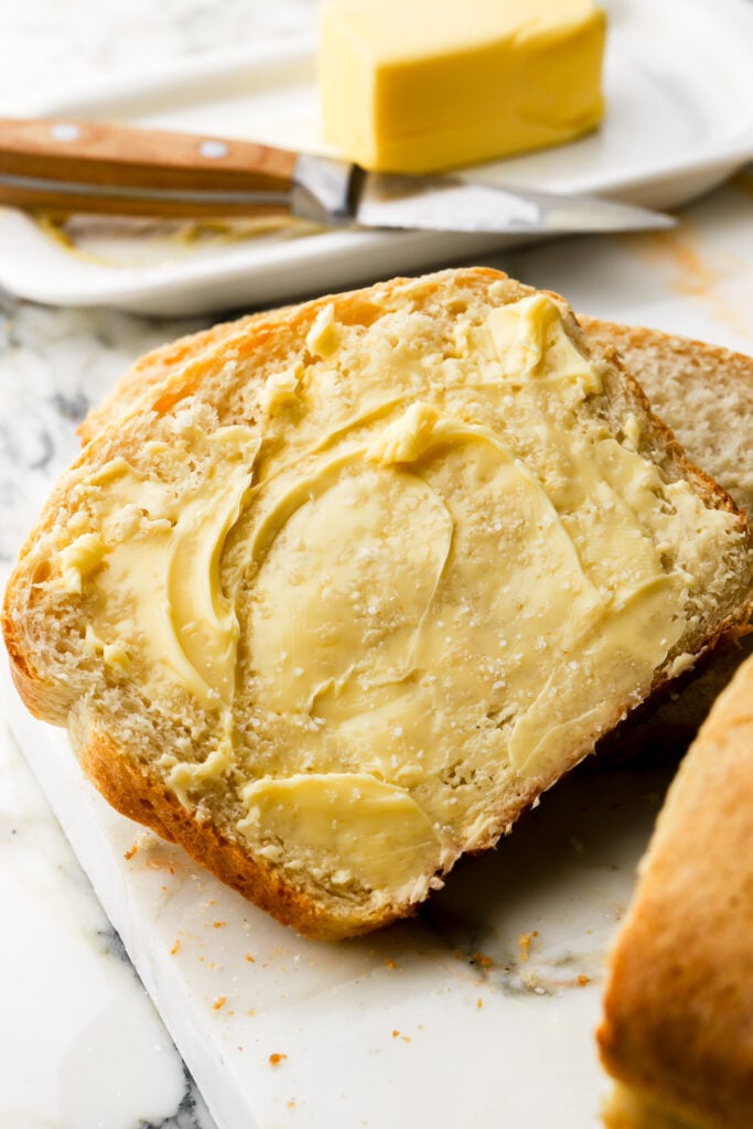 slice of bread with butter spread on it
