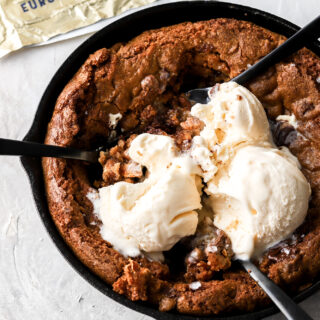 skillet cookie with ice cream and spoons