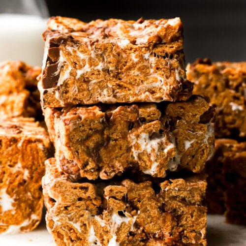 s'mores bars stacked with milk behind