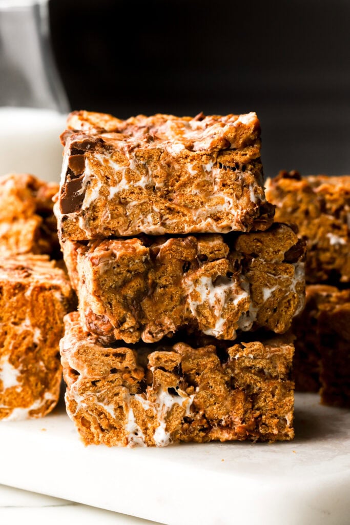 s'mores bars stacked with milk behind