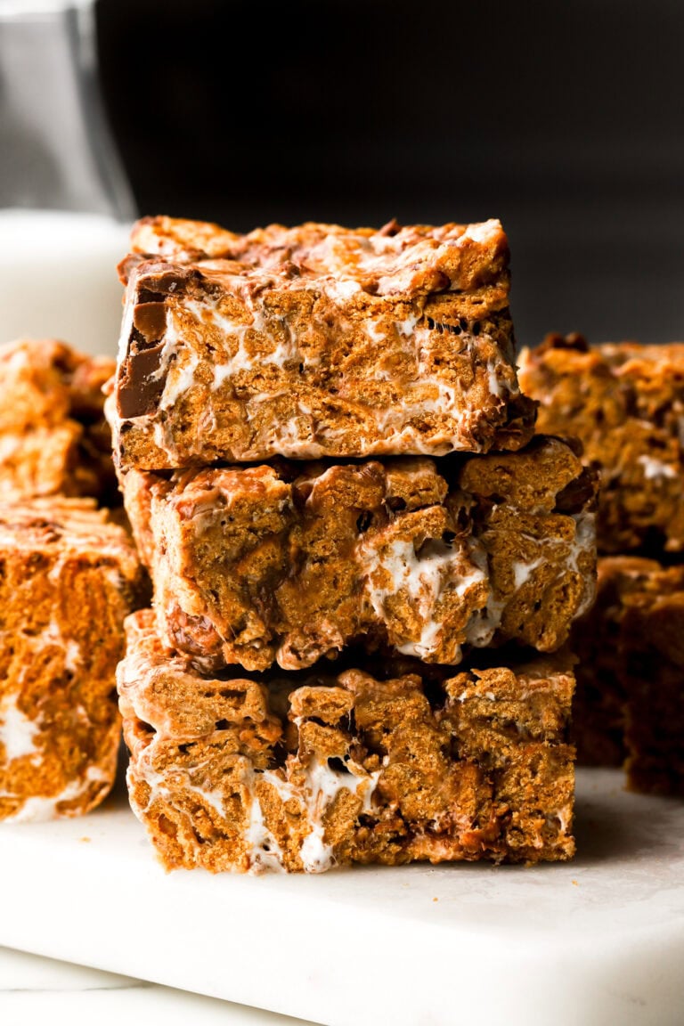 s'mores bars stacked with milk behind