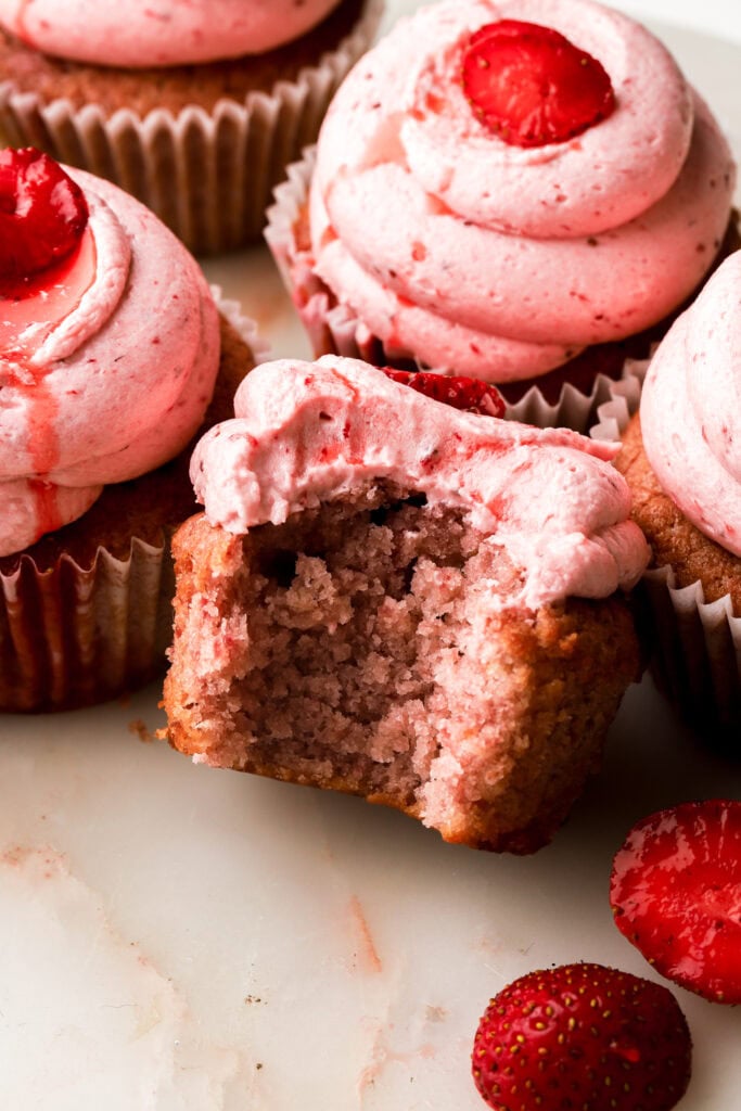 bite taken out of a strawberry cupcake
