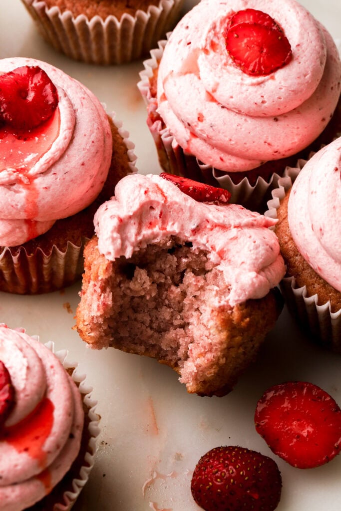 bite taken out of a strawberry cupcake