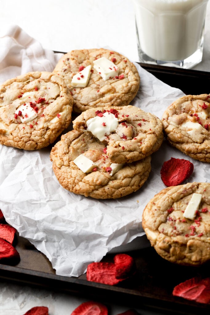 strawberry white chocolate chip cookies on a sheet of parchment paper