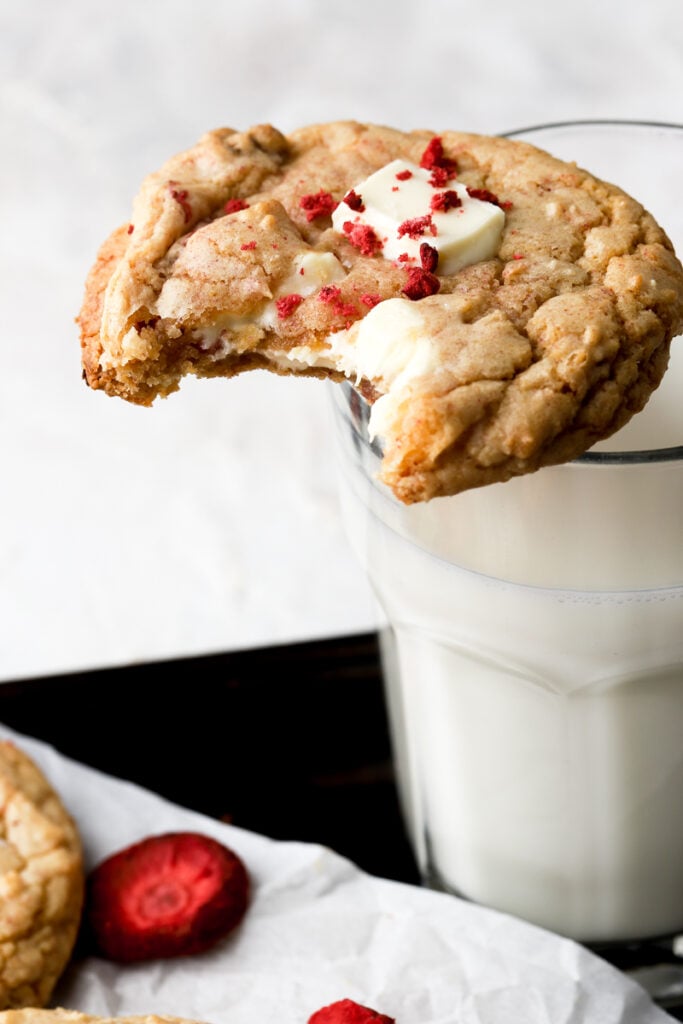 cookie on top of a glass of milk