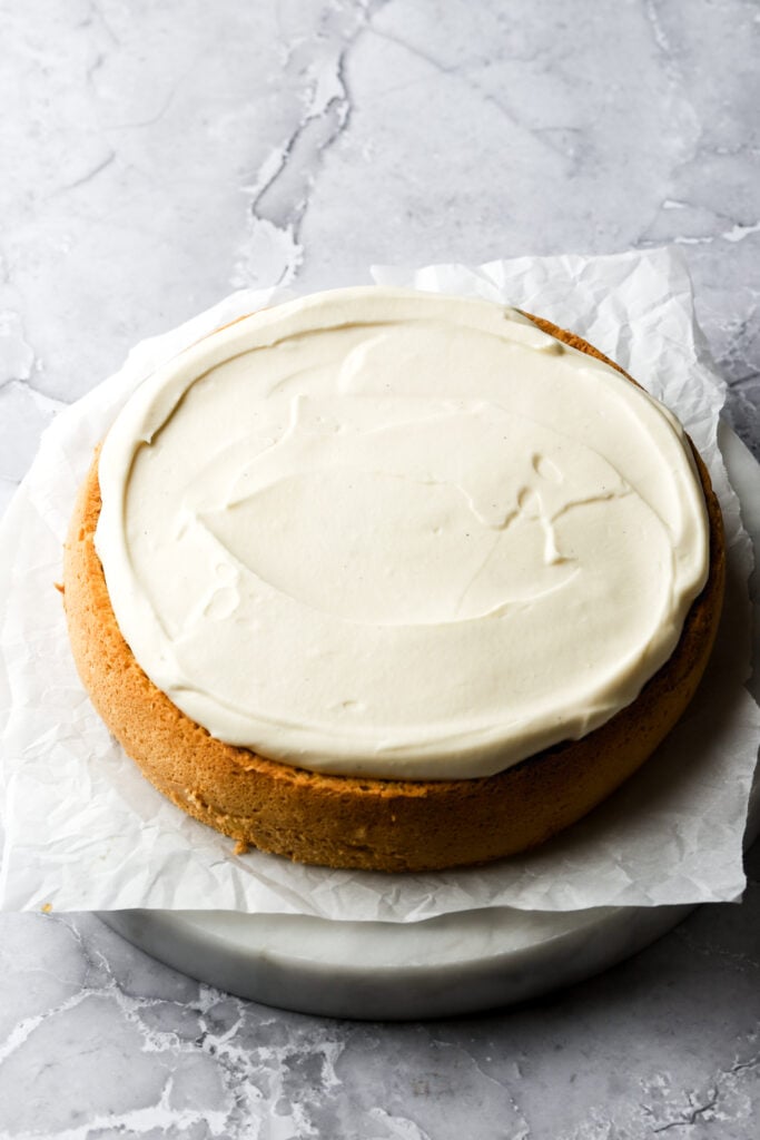 first layer of cake frosted with cream