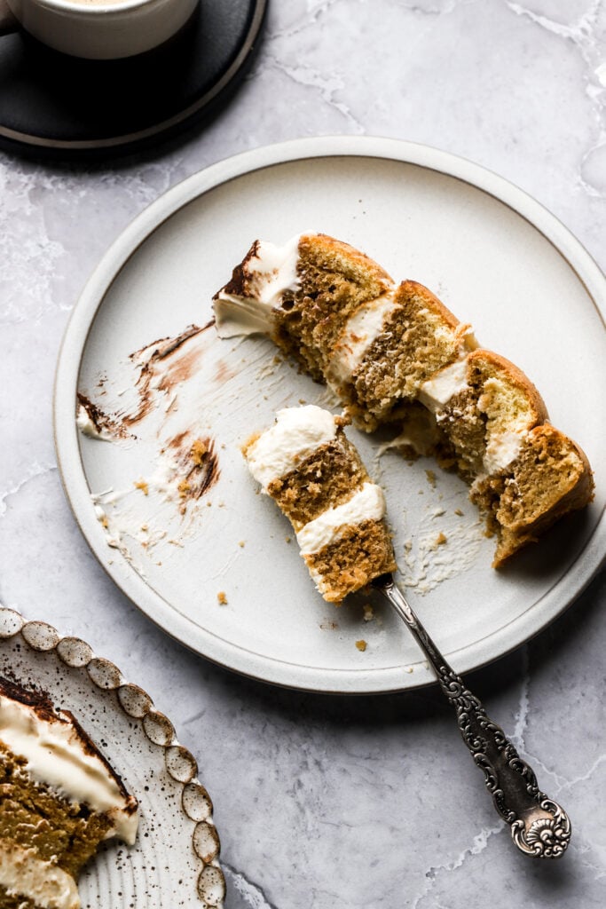 slice of cake on a plate, mostly eaten