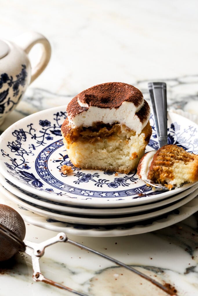 tiramisu cupcakes frosted with mascarpone frosting and dusted with cocoa powder