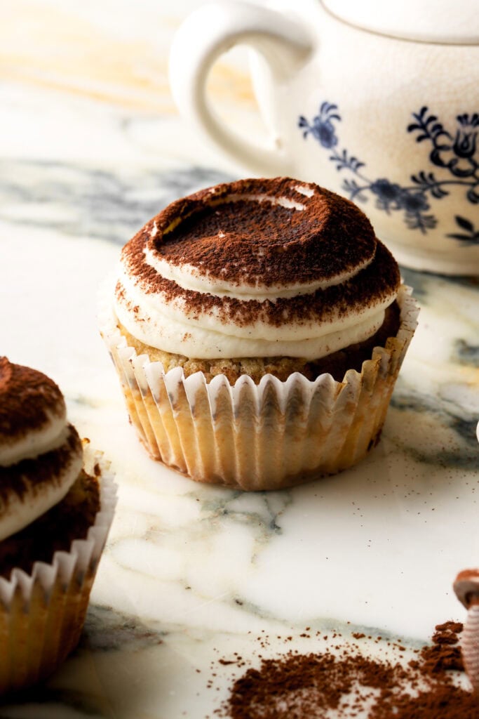 tiramisu cupcakes frosted with mascarpone frosting and dusted with cocoa powder