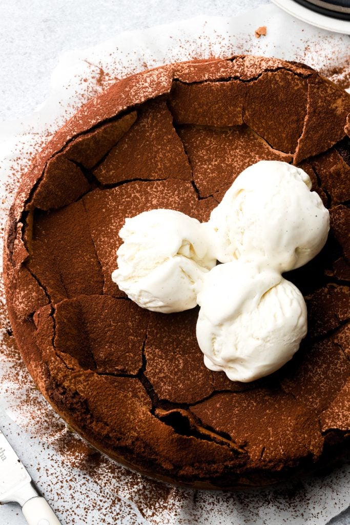 torte tenerina topped with cocoa powder and ice cream